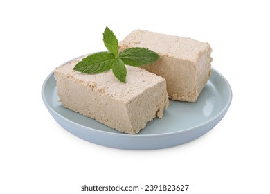 Plate with pieces of tasty halva and mint isolated on white