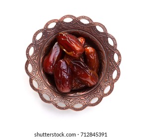 Plate of pitted dates isolated on white background. Top view