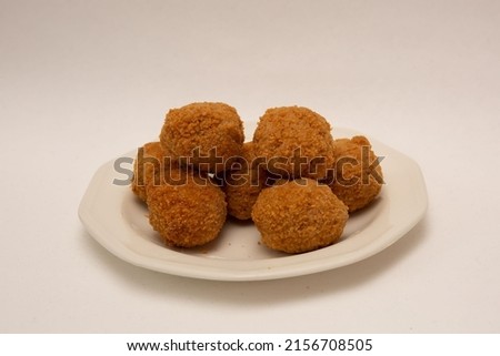A plate of pork sausagemeat and chopped boiled eggs fried in crispy breadcrumbs