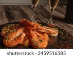 plate of prawns, with top view, accompanied by a glass of white wine. with spaces for writing and placing text.