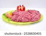 A plate of raw ground beef mince, also known as minced meat or beef crumbles. The meat is a vibrant red color and appears to be finely chopped.