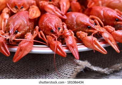 Plate With Red Boiled Crawfish On A Wooden Table In Rustic Style, Close-up, Selective Focus On One Crawfish