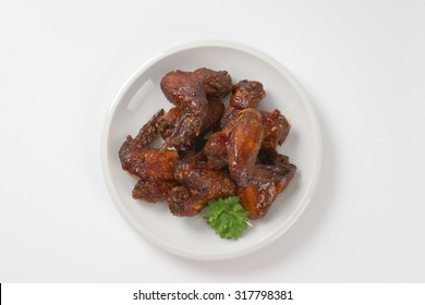 Plate Of Roasted Chicken Wings On White Background