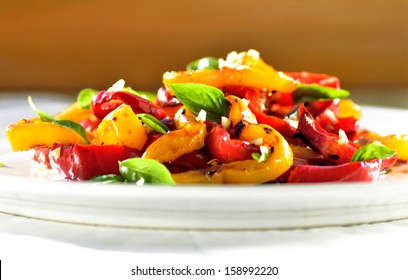 Plate Of Roasted Vegetables, Sweet Red And Yellow Peppers With Basil.Light, Healthy, Vegan Mediterranean Salad.