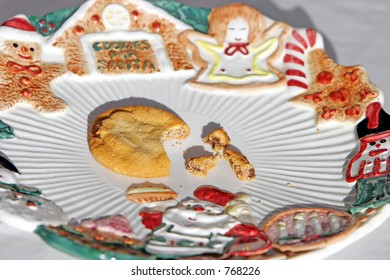 A Plate For Santa's Cookies, And He Left Only One Half-eaten Cookie Left, And Some Crumbs (close-up).