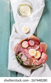 Plate With Sausage And Pate Variation, Served With Herbs, Bread And Glass Of White Wine Over Turquoise Wooden Table. Overhead View. 