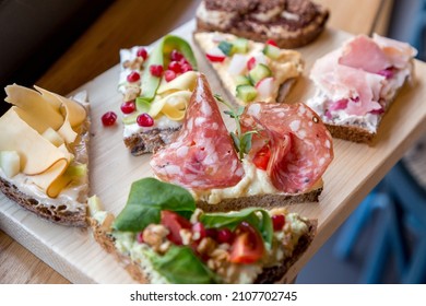 Plate with Scandinavian style open-faced colorful sandwiches.