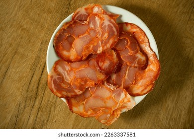 Plate with slices of paio. Paio is a traditional pork sausage from the Alentejo region of Portugal. - Shutterstock ID 2263337581