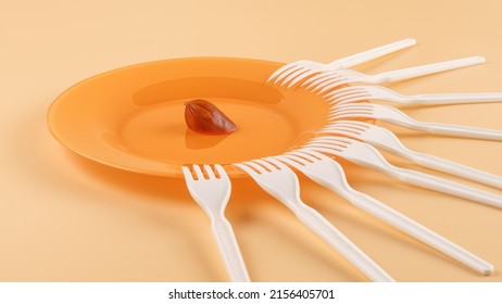 Plate With A Small Piece Of Sausage And A Lot Of Plastic Forks. Haring, Limited Resources, Shortage And Contention Concep