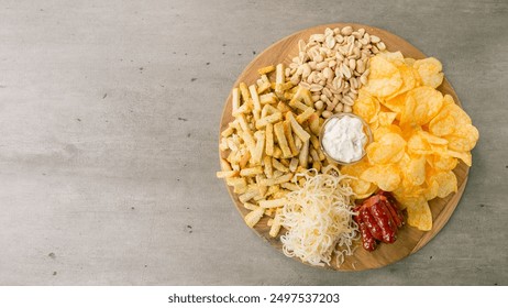 plate of snacks chips, croutons, sausages, cheese, nuts - Powered by Shutterstock