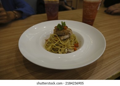 A Plate Of Spaghetti Aglio Olio With Smoked Fish As Topping