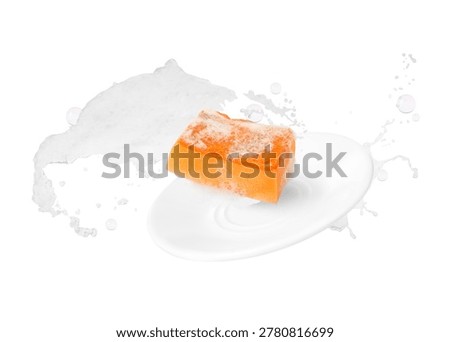 Plate with sponge, suds and soap bubbles on white background