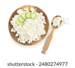 Plate and spoon of tasty cottage cheese on white background