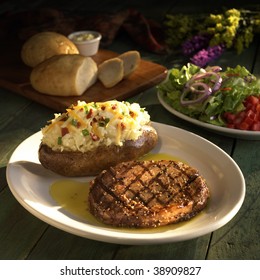 Plate Of Steak With Baked Potato, Salad And Bread