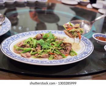 Plate Of Stir Fried Goat Meat Or Chevon With Ginger Slice, Chili And Mixed Vegetables Place On Lazy Susan Table. Traditional Chinese Food With Selective Focus.