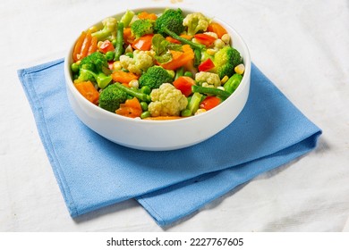 plate of stir fry vegetables on wooden table, top view