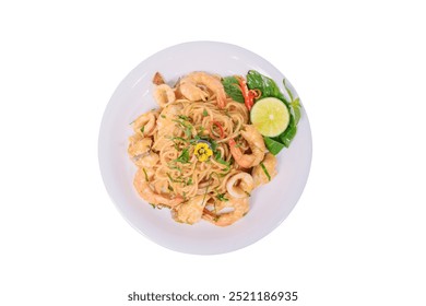 A plate of stir-fried spaghetti with seafood, vegetables, and a flavorful sauce, garnished with a flower and lime wedge. - Powered by Shutterstock