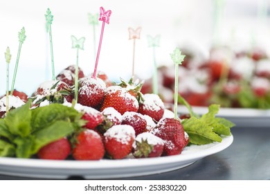 Plate Of Succulent Juicy Fresh Ripe Red Strawberrie On Multicolored Plastic Food Skewers In Butterfly And Leaf Shape Decorated With Mint