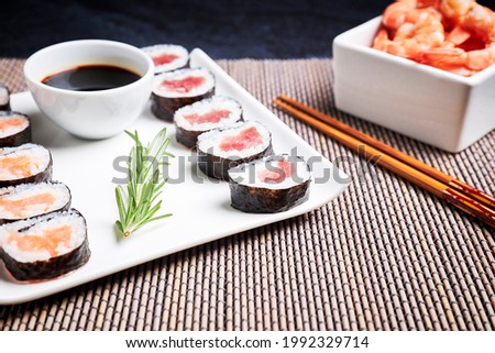 Plate with sushi, shrimp bowl and wooden chopsticks. Asian food. Healthy food concept. Food culture.