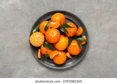 https://image.shutterstock.com/image-photo/plate-sweet-mandarins-leaves-on-260nw-2391082369.jpg