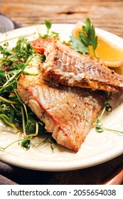 Plate With Tasty Baked Cod Fillet And Vegetables On Table, Closeup