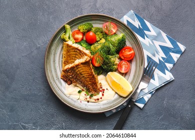 Plate With Tasty Baked Cod Fillet And Vegetables On Dark Background