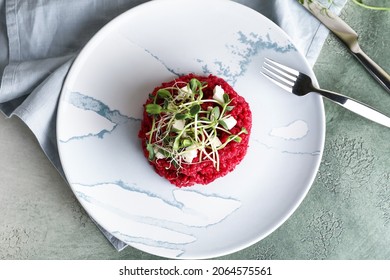 Plate with tasty beet risotto on color background