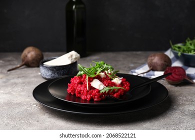 Plate with tasty beet risotto on grey background