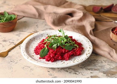 Plate with tasty beet risotto on grunge background
