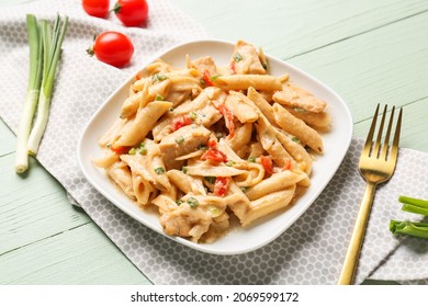 Plate With Tasty Cajun Chicken Pasta On Color Wooden Background, Closeup