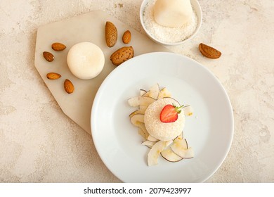 Plate with tasty coconut mochi on grunge background