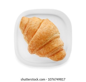 Plate with tasty croissant on white background, top view - Shutterstock ID 1076749817