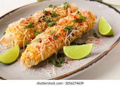 Plate with tasty Elote Mexican Street Corn on white background, closeup