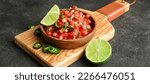 Plate of tasty Pico de Gallo salsa on dark background