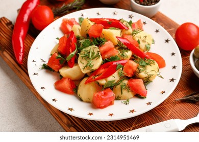 Plate of tasty Potato Salad with vegetables on light background - Shutterstock ID 2314951469
