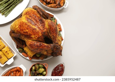 Plate with tasty roasted turkey and different dishes for Thanksgiving day on white background - Shutterstock ID 2385952487