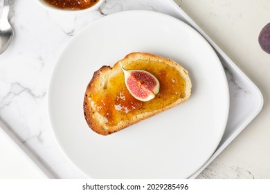 Plate With Tasty Sandwich With Fig Jam On Table