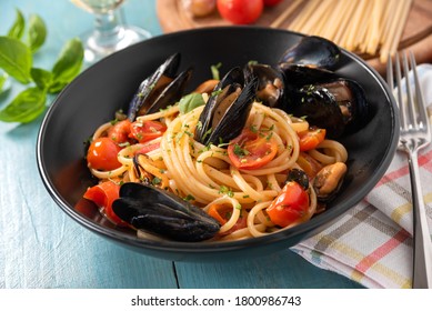 Plate of tasty spaghetti with delicious mussel and tomato sauce, Italian Cuisine - Powered by Shutterstock