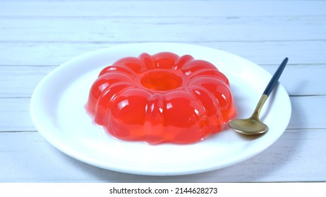 A Plate of tasty strawberry jelly served in white plate. Healthy food. Summer dessert with fruit jelly and fresh strawberry. White Background and Base. Harsh light. Agar Agar.  - Shutterstock ID 2144628273