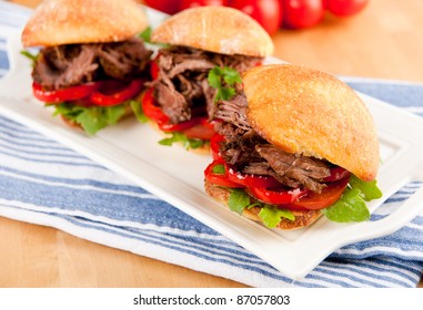 Plate Of Three Tiny Slider Sandwiches With Pulled Beef And Red Bell Peppers