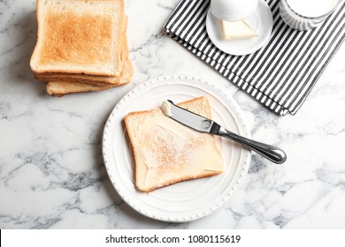 Plate With Toasted Bread And Butter On Table, Top View