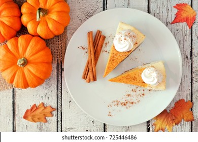 Plate With Two Slices Of Pumpkin Cheesecake With Whipped Cream, Overhead View On A White Wood Background