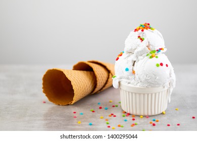 Plate Of Vanilla Ice Cream Scoop Swith Sprinkles And Waffle Cones  With Copy Space.