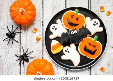 Plate with a variety of spooky Halloween cookies. Overhead view with decor on a white wood table background. - Powered by Shutterstock