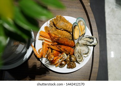 Plate Of Various Types Of Seafood Set, Steamed Rock Lobster, Baby Lobster, New Zealand Mussel, Blue Crab And Fresh Pacific Oyster, Dinner Buffet Seafood Night.