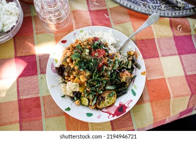 A Plate With Vegan Persian Mezze Specialties, Rice, Zucchini, Hummus, Salad And Chutney.