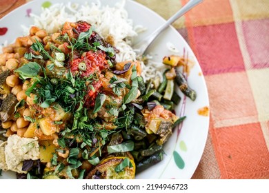 A Plate With Vegan Persian Mezze Specialties, Rice, Zucchini, Hummus, Salad And Chutney.