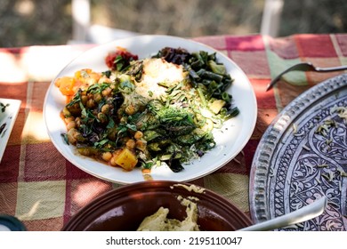 A Plate With Vegan Persian Mezze Specialties, Rice, Zucchini, Hummus, Salad And Chutney.