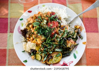 A Plate With Vegan Persian Mezze Specialties, Rice, Zucchini, Hummus, Salad And Chutney.