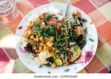 A Plate With Vegan Persian Mezze Specialties, Rice, Zucchini, Hummus, Salad And Chutney.